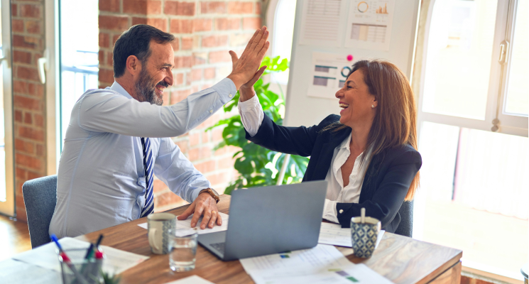 two business people high five each other