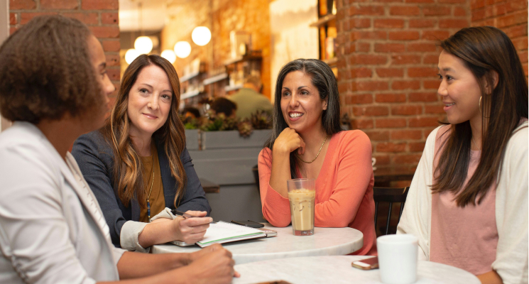 Four coworkers having a coffee break together